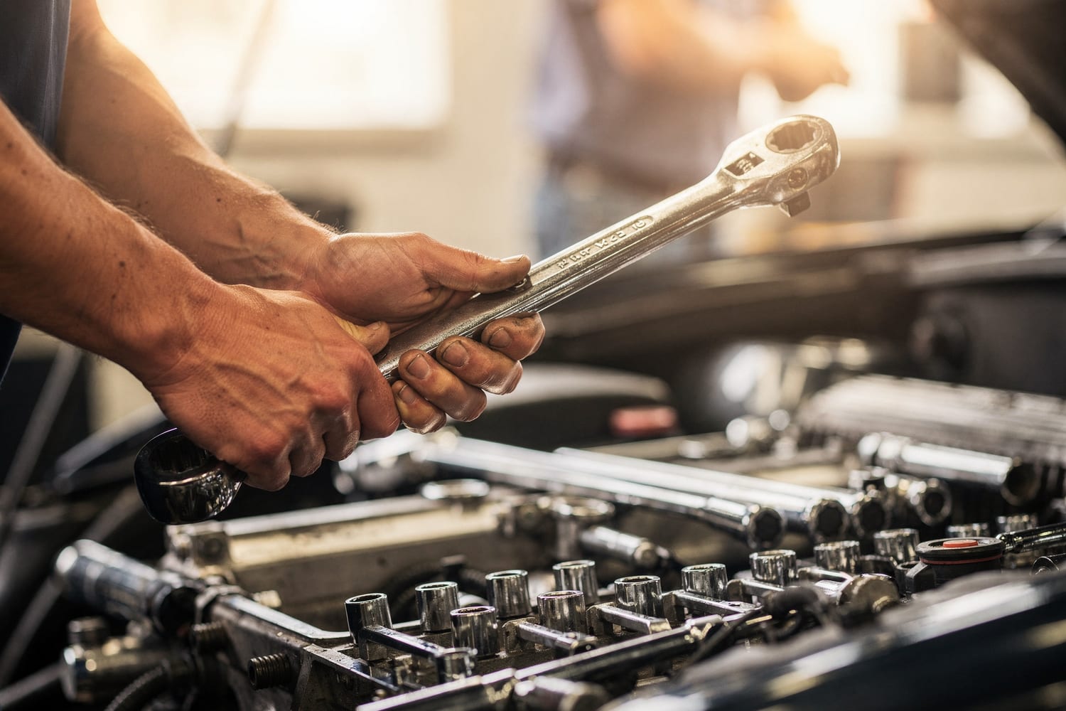 A P & A technician working on an engine with a wrench